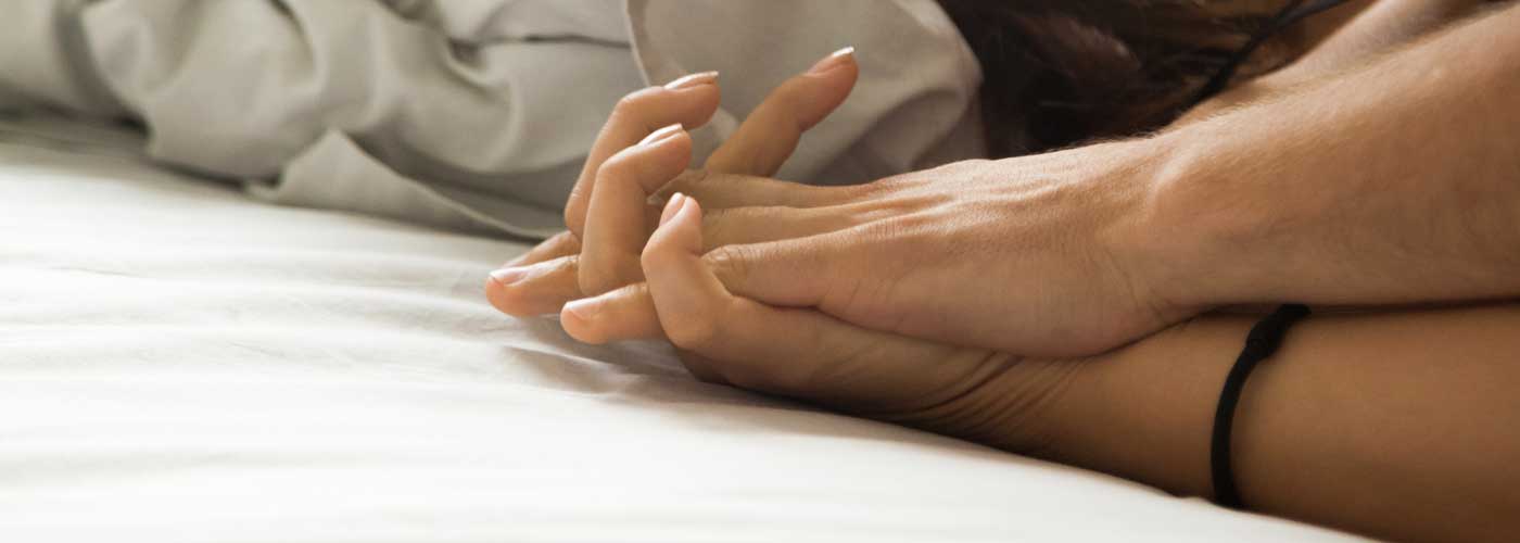 Two hands interlocking fingers