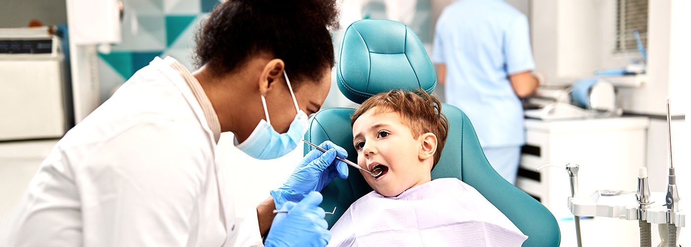 Dentist examining child's teeth