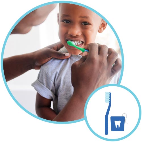 Adult brushing child's teeth