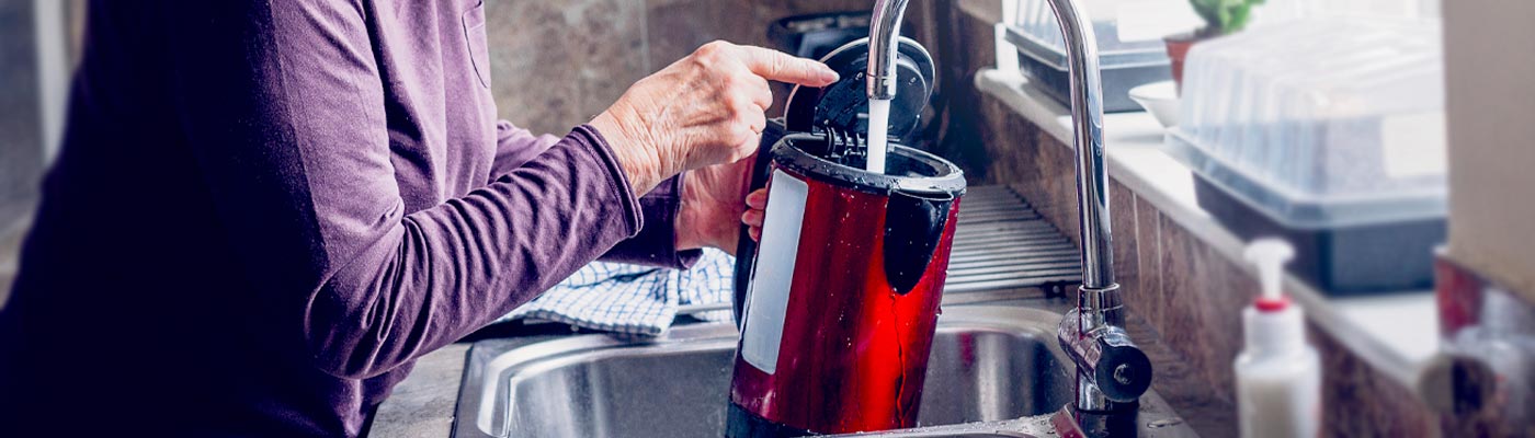 Boil water advisory Adult filling kettle with tap water