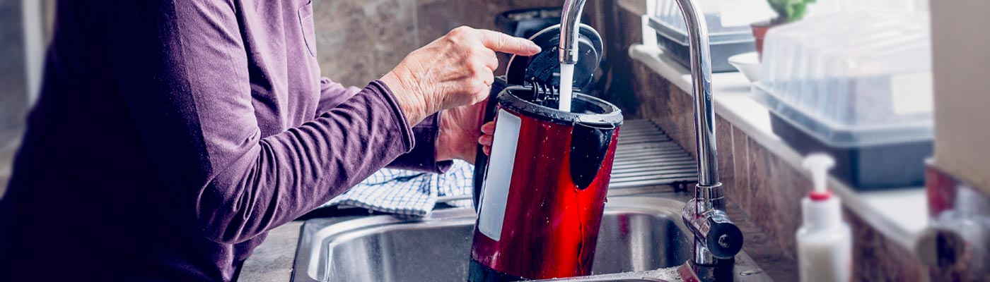 Adult filling kettle with tap water