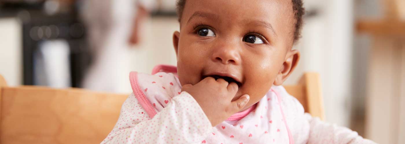 baby with hand in their mouth