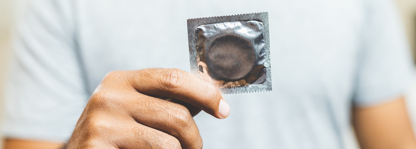 Person holding wrapped condom