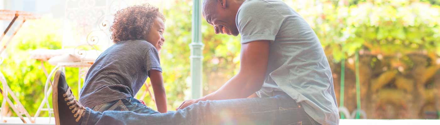 child and adult smiling at each other