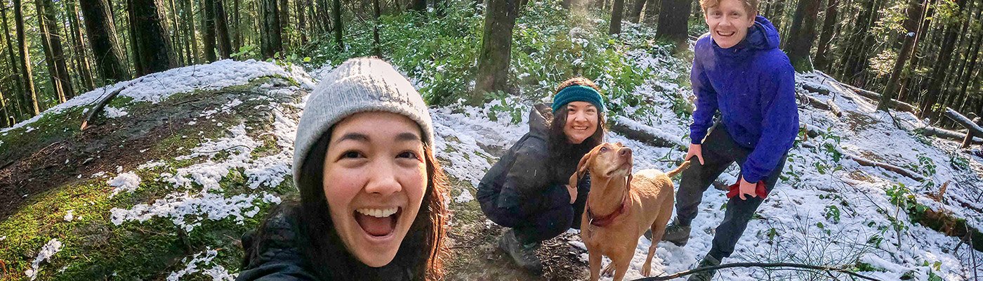 people smiling on a hiking trail