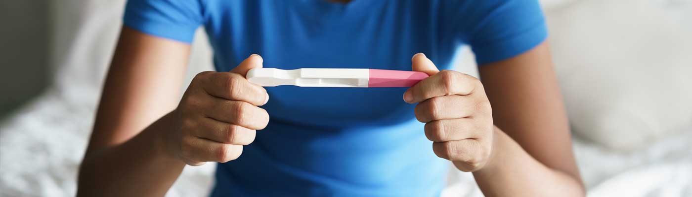 Person holding a pregnancy test in both hands