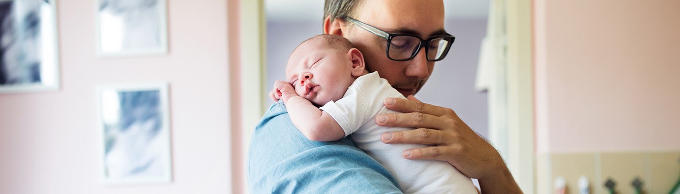 Adult holding sleeping baby