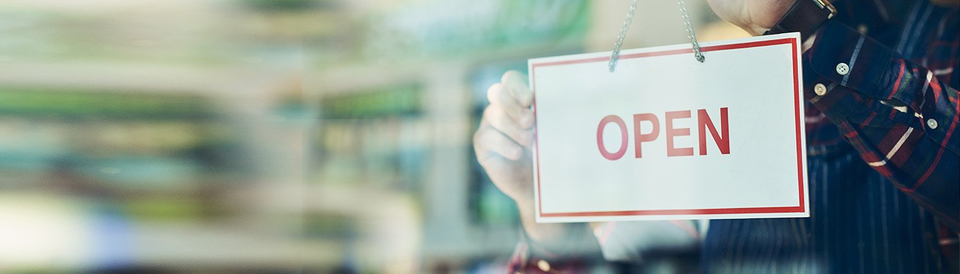 Hands holding an open sign